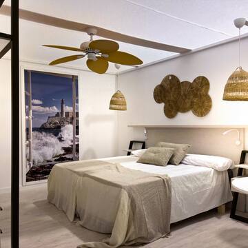 a bedroom with a bed and ceiling fan
