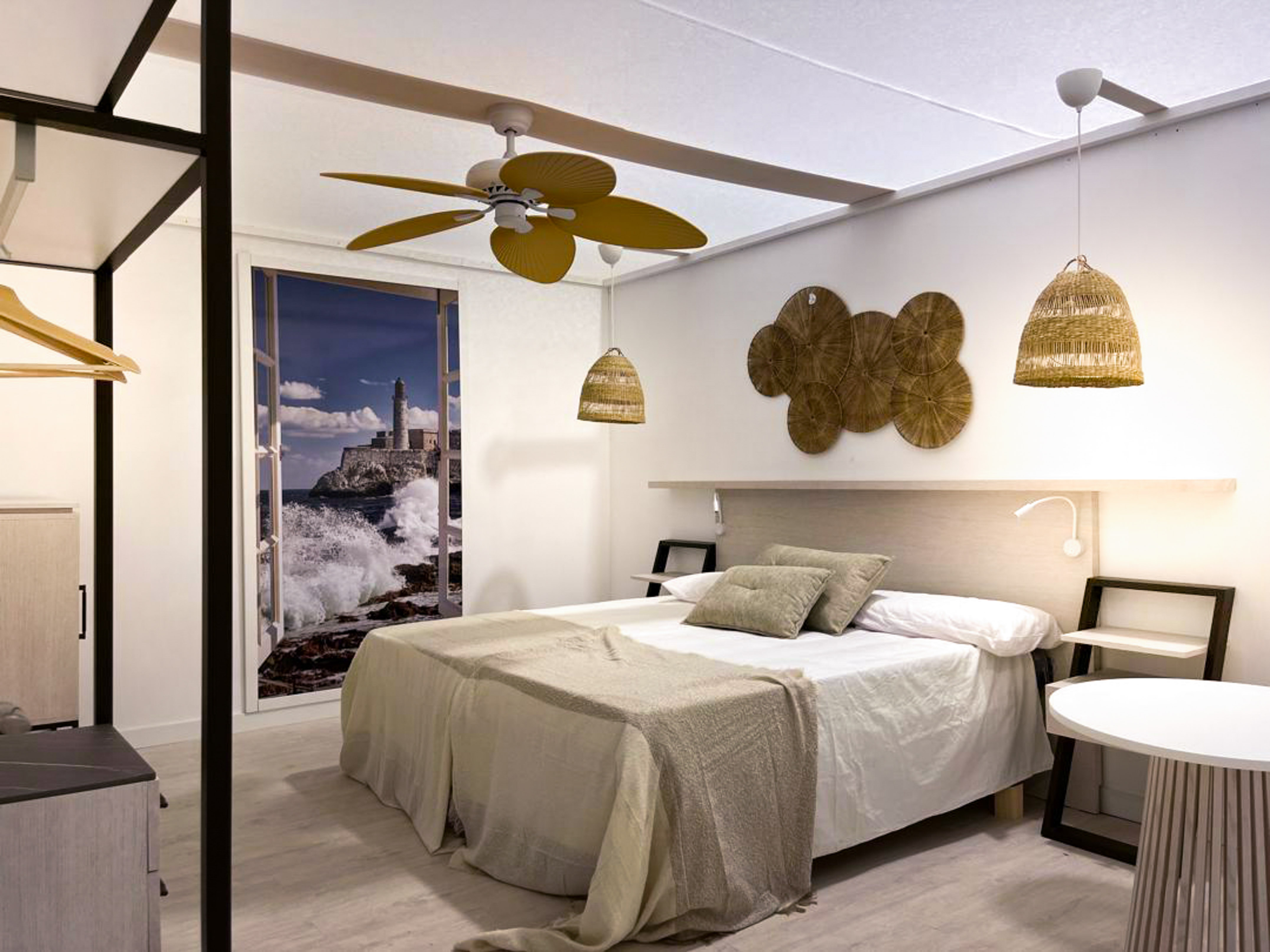 a bedroom with a bed and ceiling fan
