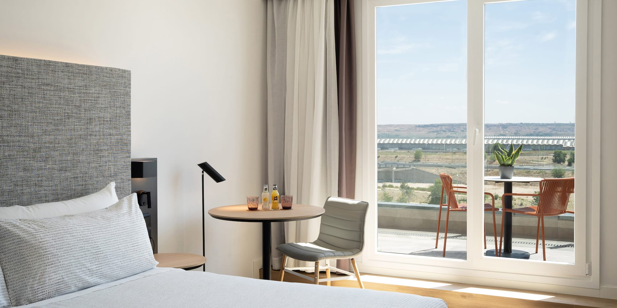 a bedroom with a table and chairs