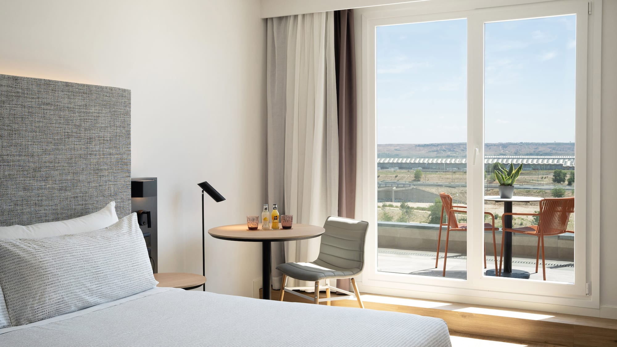 a bedroom with a table and chairs