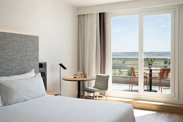 a bedroom with a table and chairs