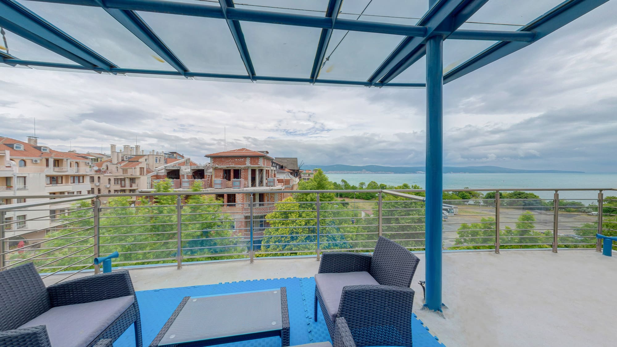 a patio with a view of a city and water
