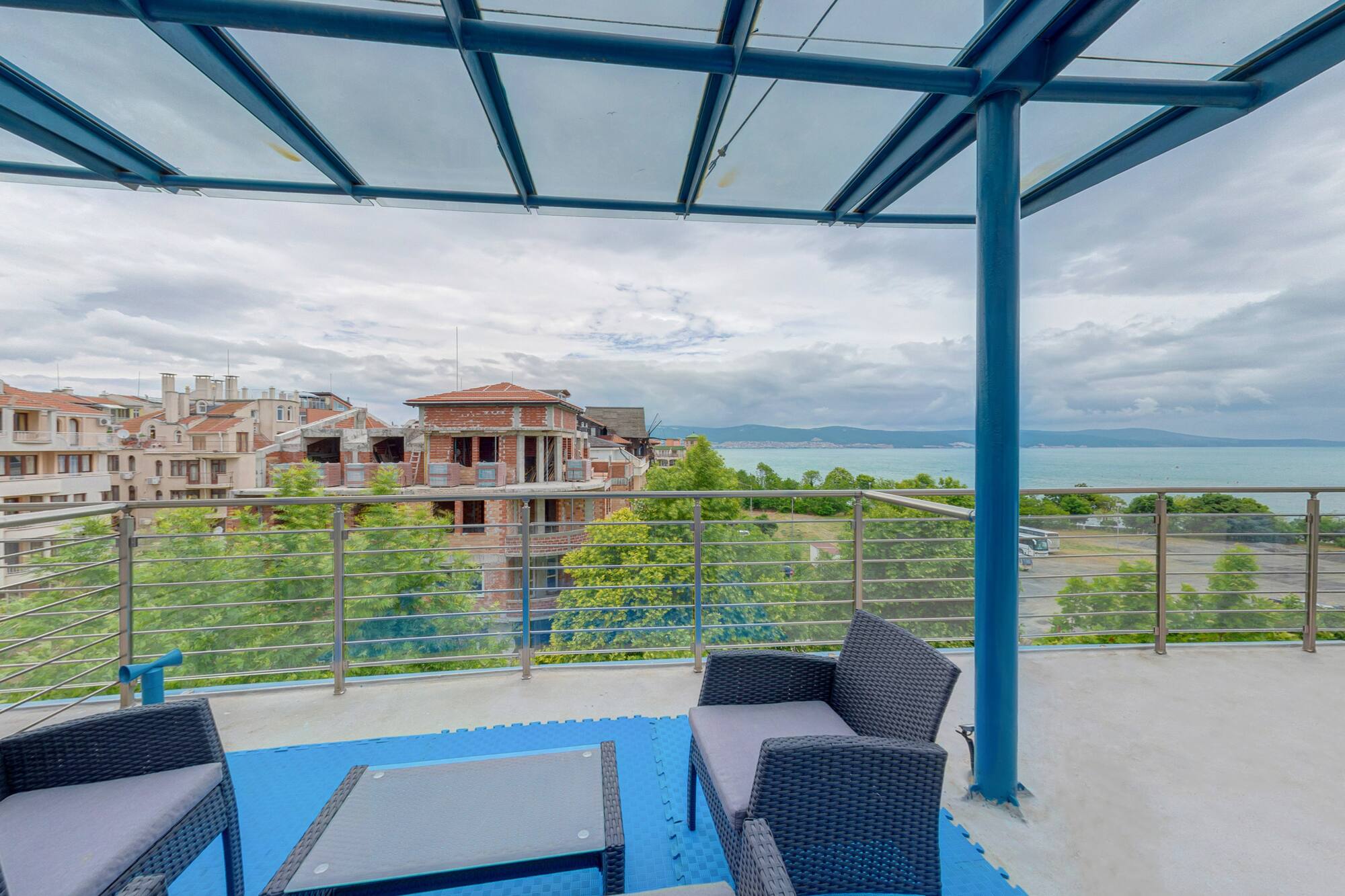 a patio with a view of a city and water