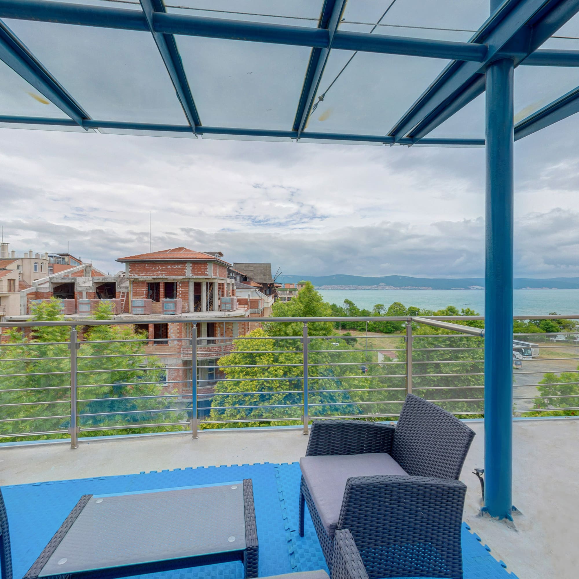a patio with a view of a city and water