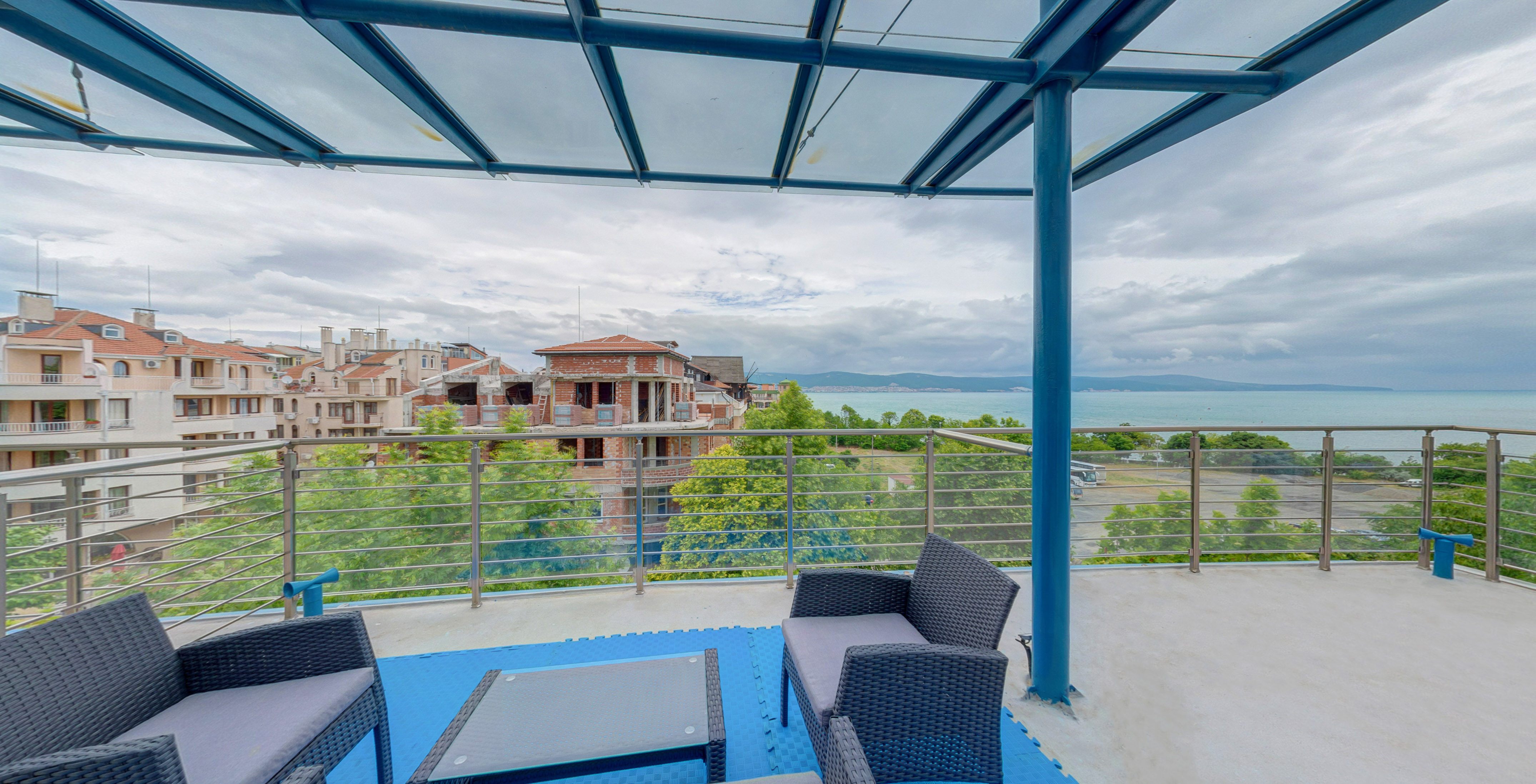 a patio with a view of a city and water
