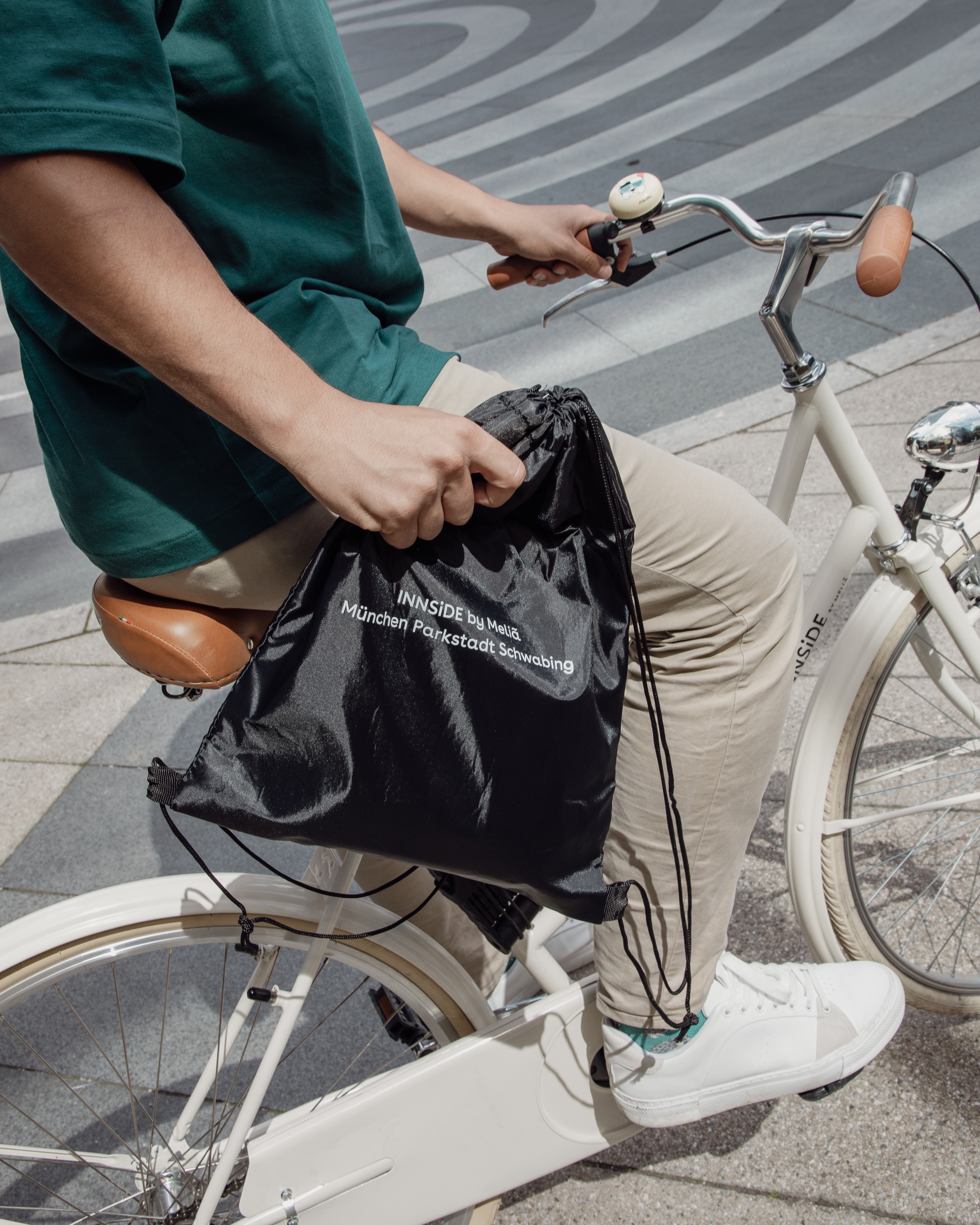 a person on a bicycle holding a bag