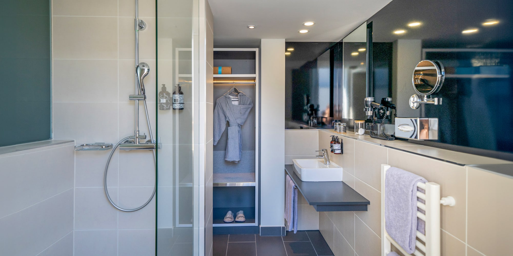 a bathroom with a shower and a bathrobe