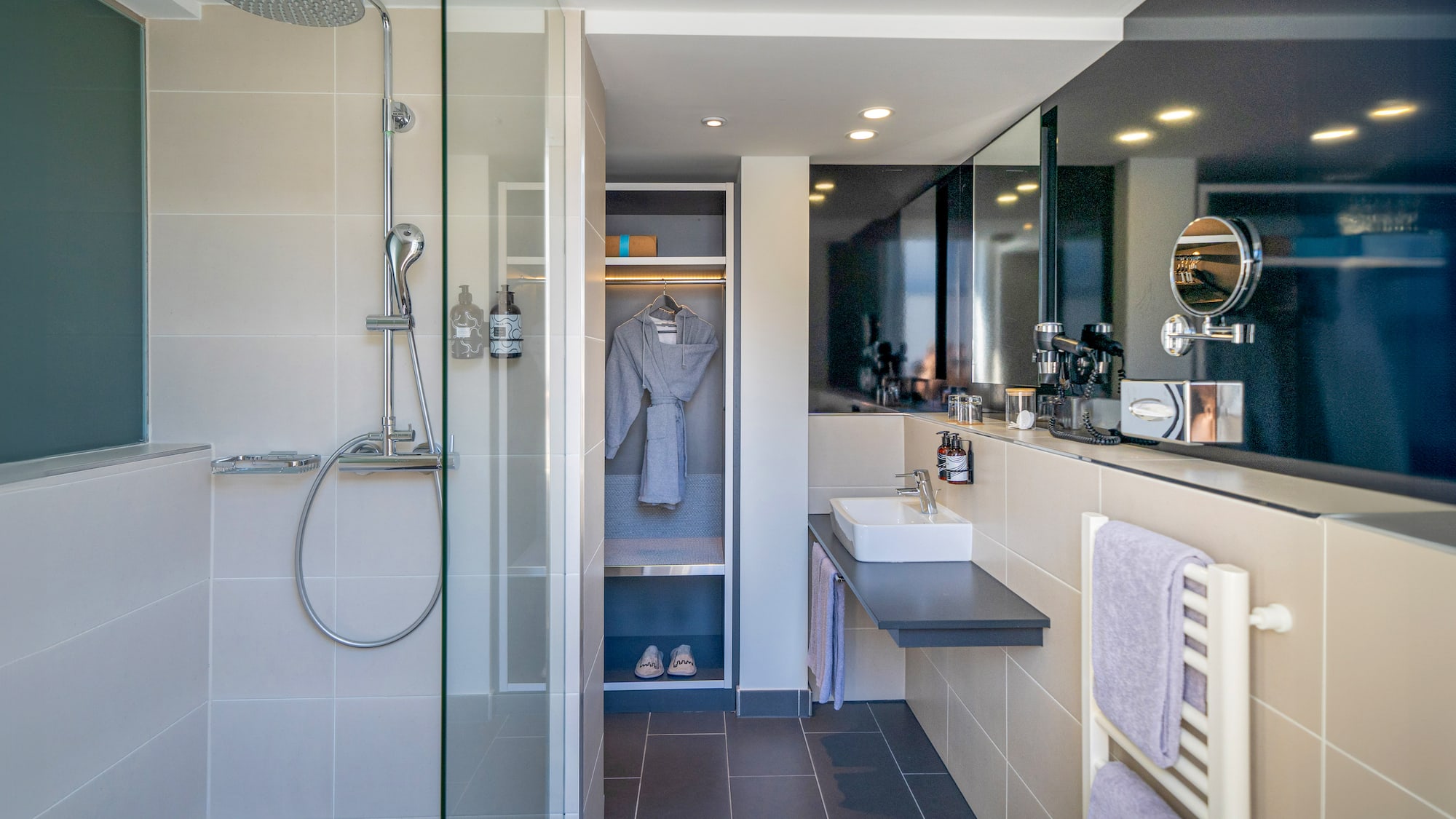 a bathroom with a shower and a bathrobe