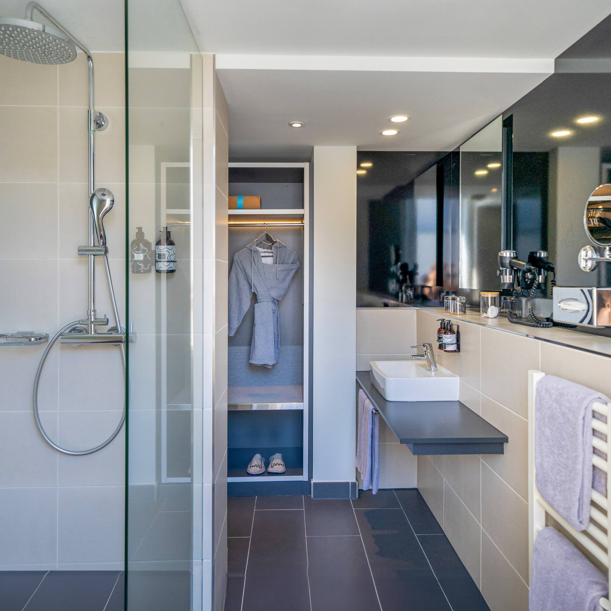 a bathroom with a shower and a bathrobe