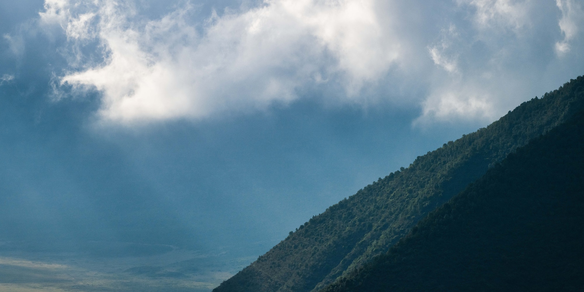 a mountain with clouds in the sky