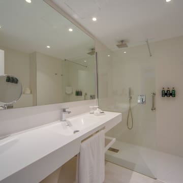 a bathroom with a glass shower and sink