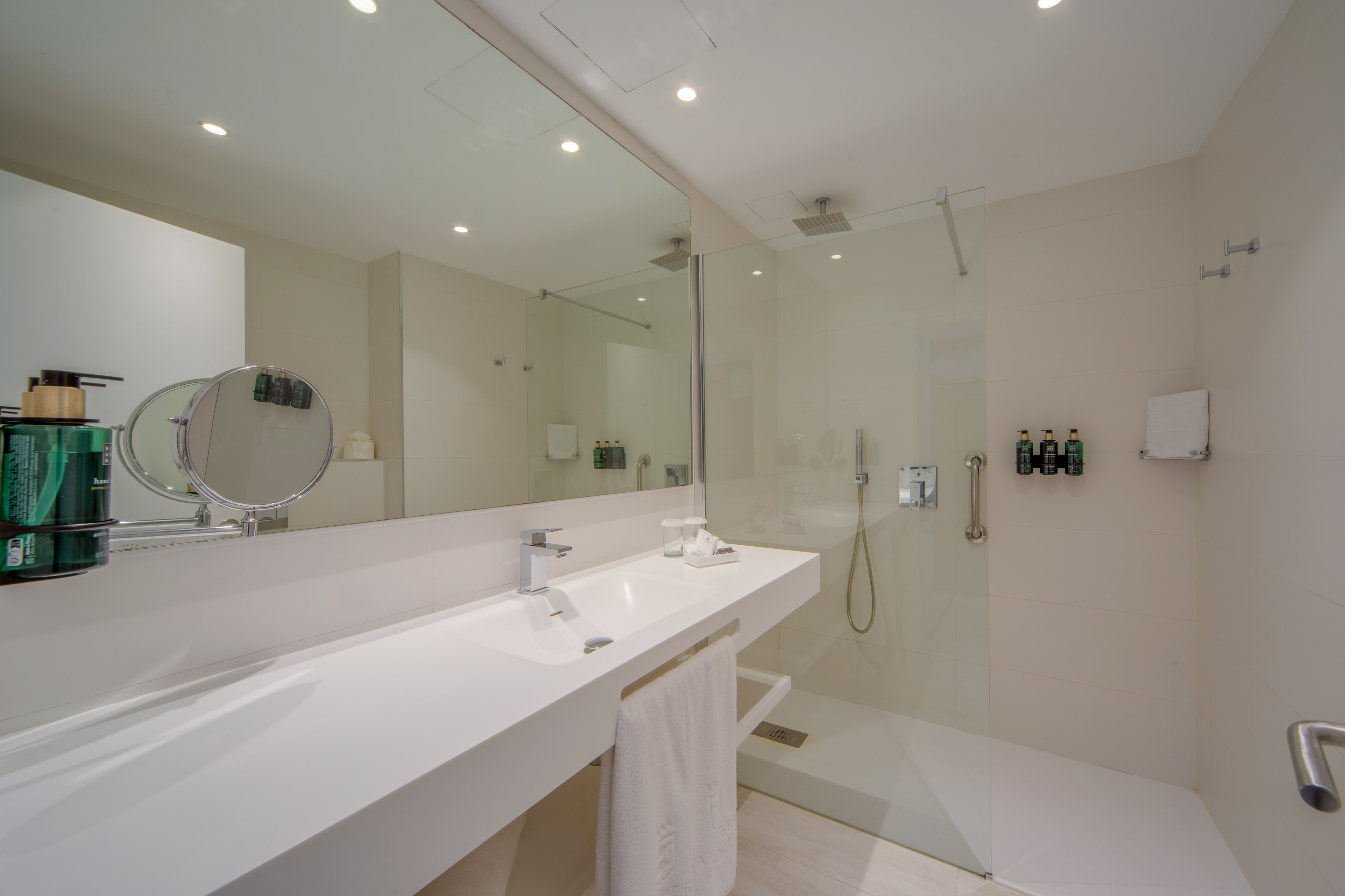 a bathroom with a glass shower and sink