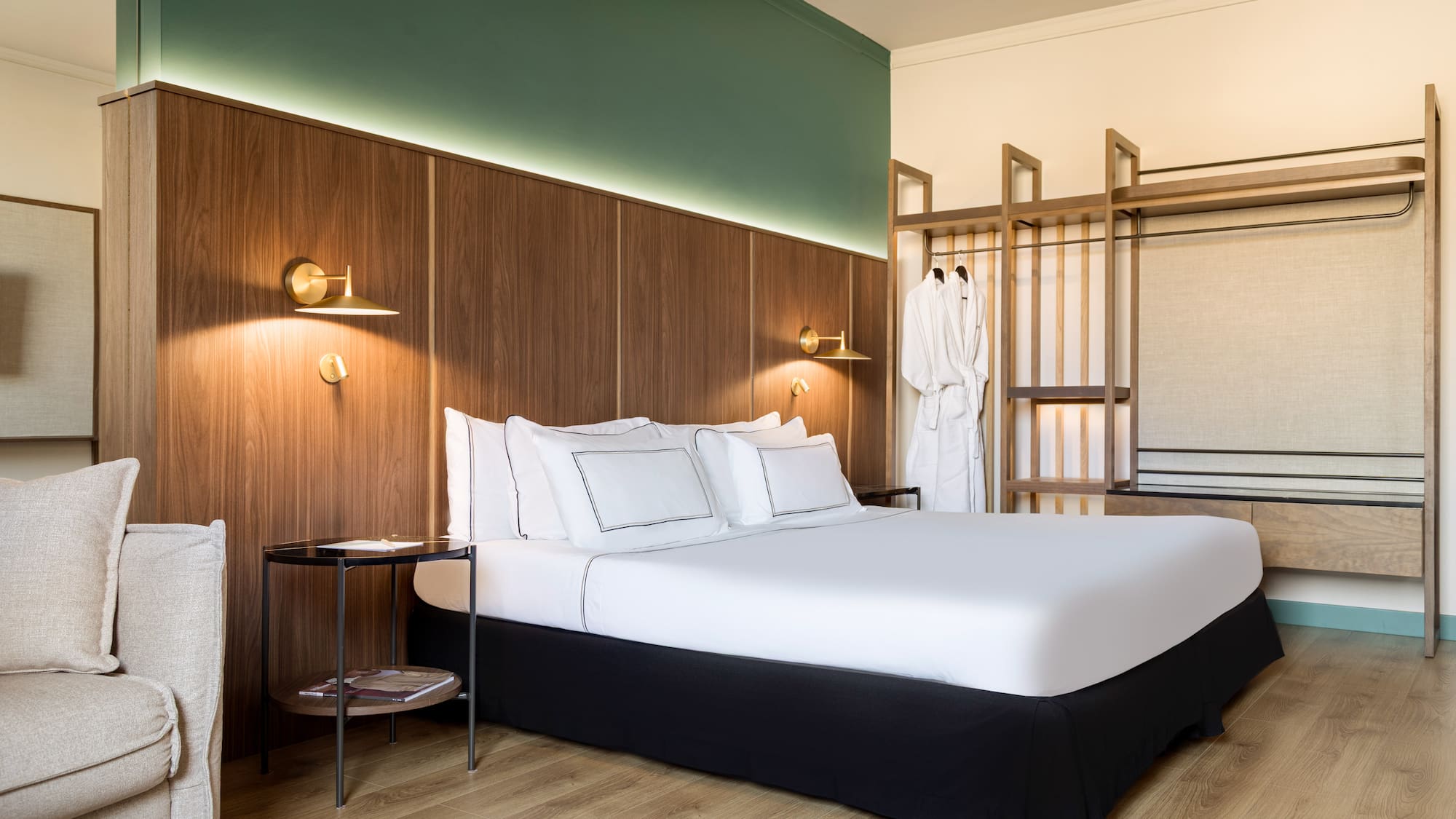 a bed with white sheets and a wood paneled wall