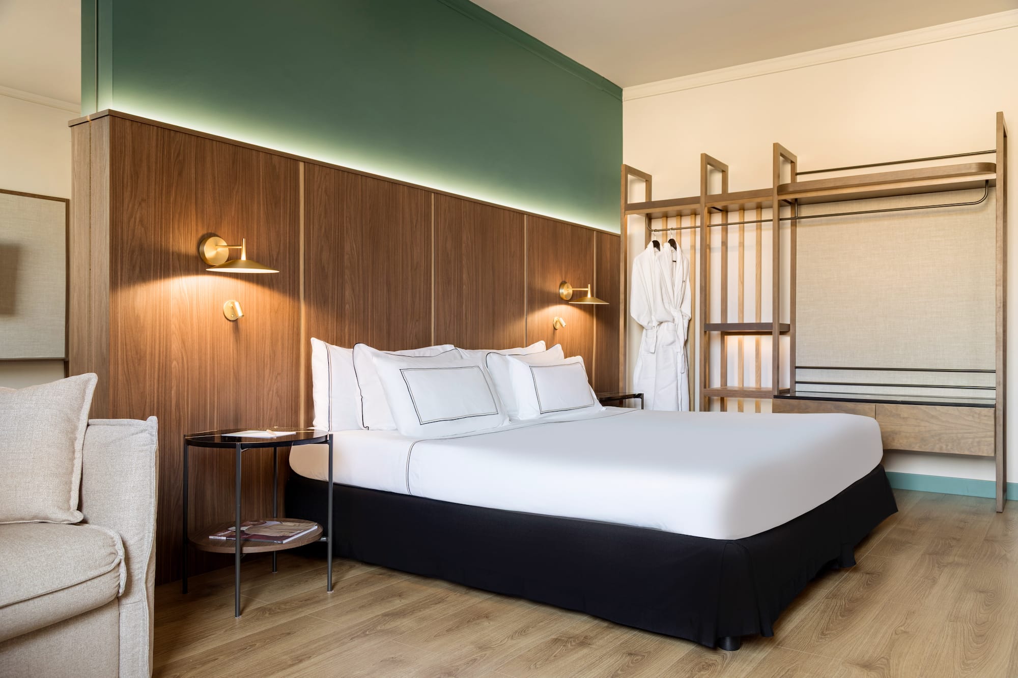 a bed with white sheets and a wood paneled wall
