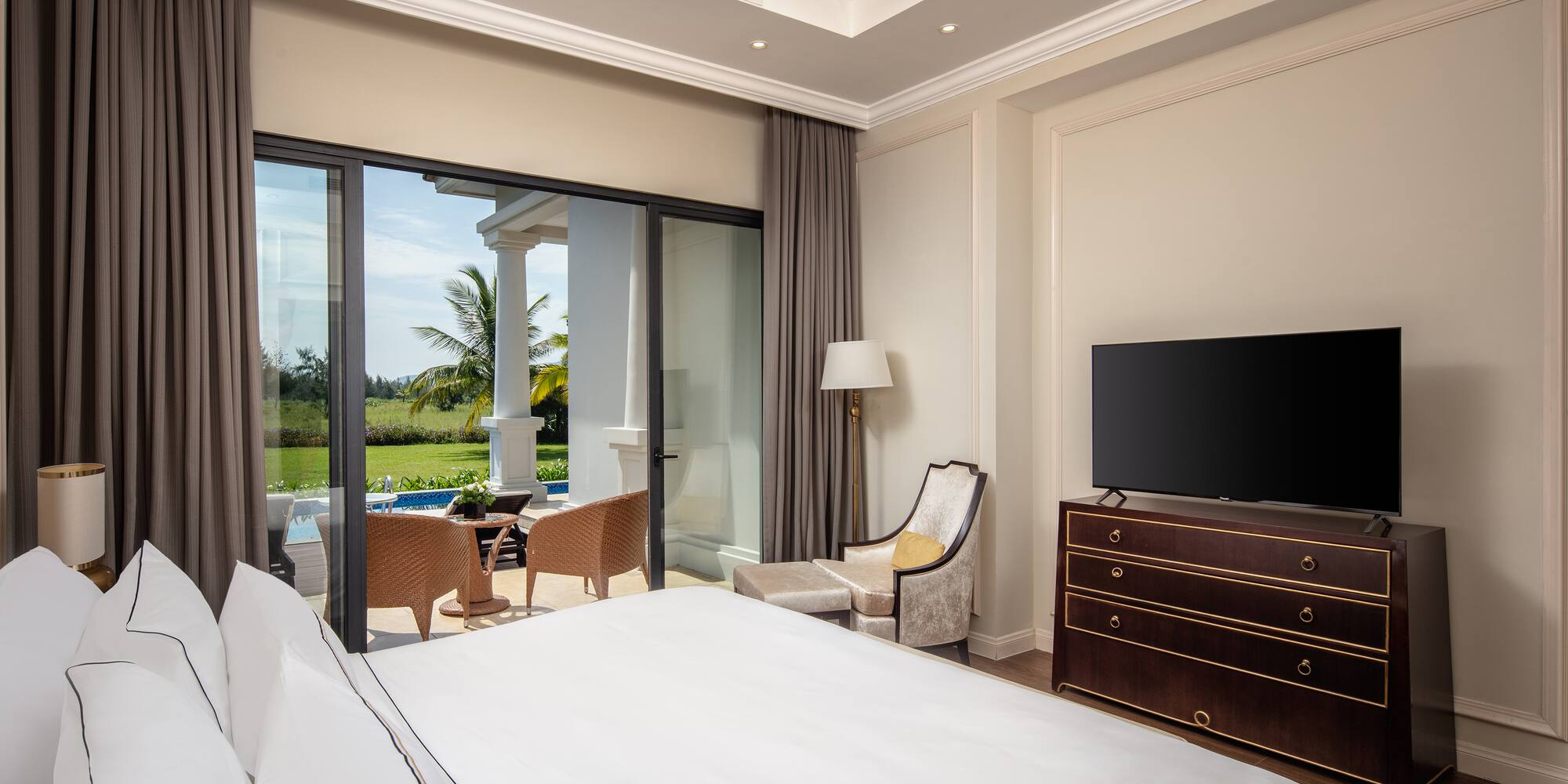 a bedroom with a television and a large window