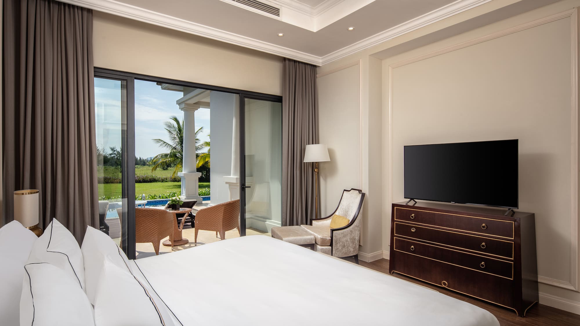 a bedroom with a television and a large window