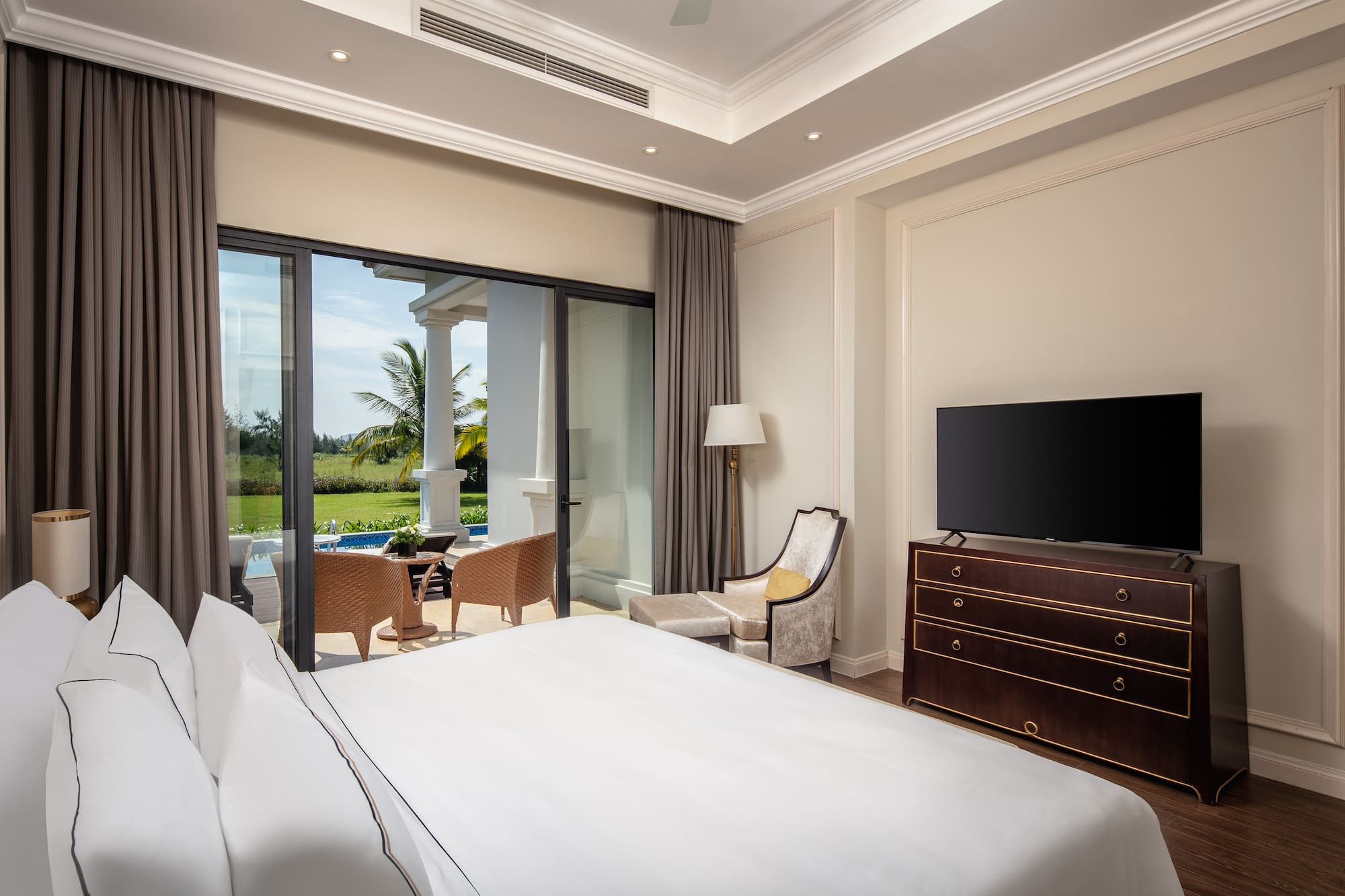 a bedroom with a television and a large window