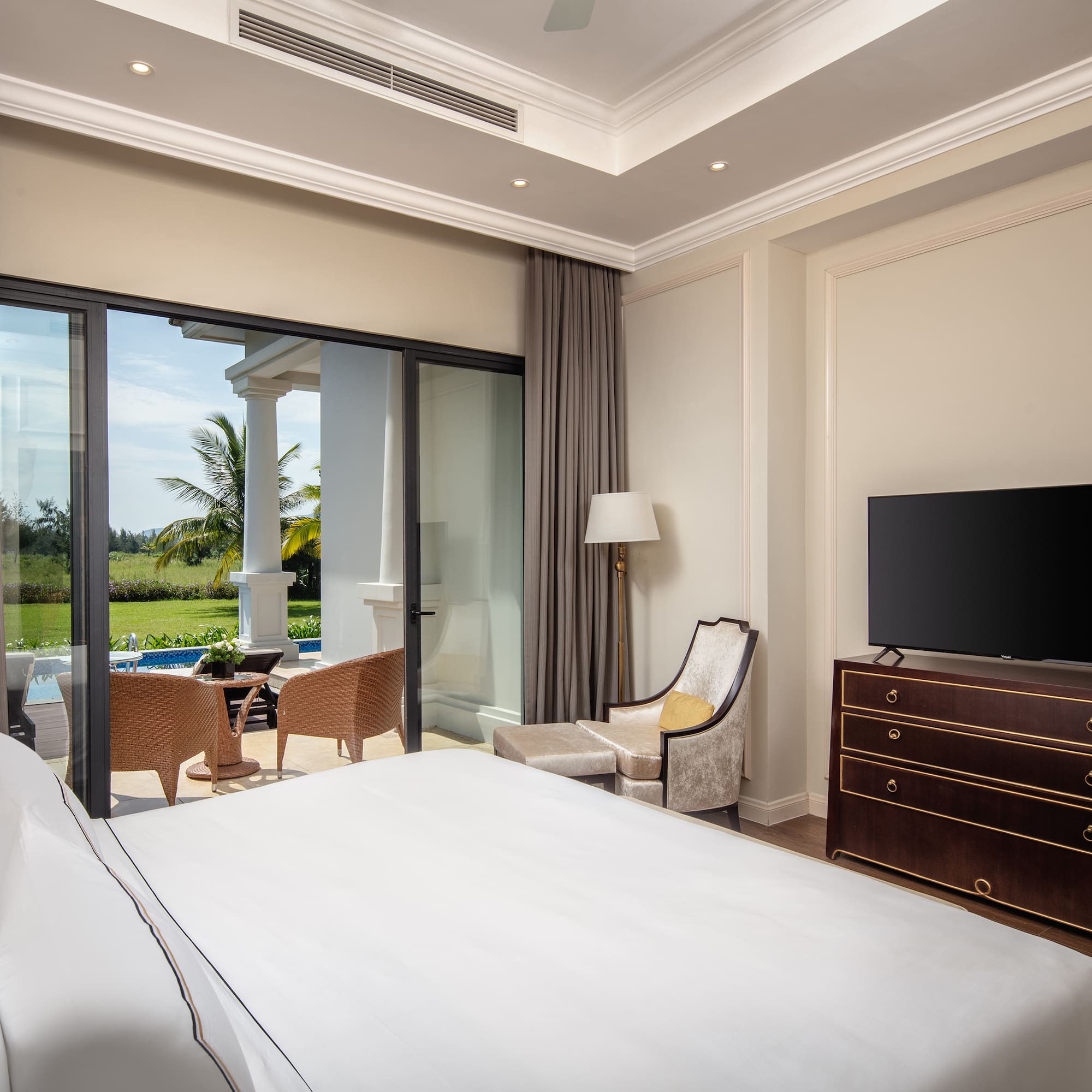 a bedroom with a television and a large window