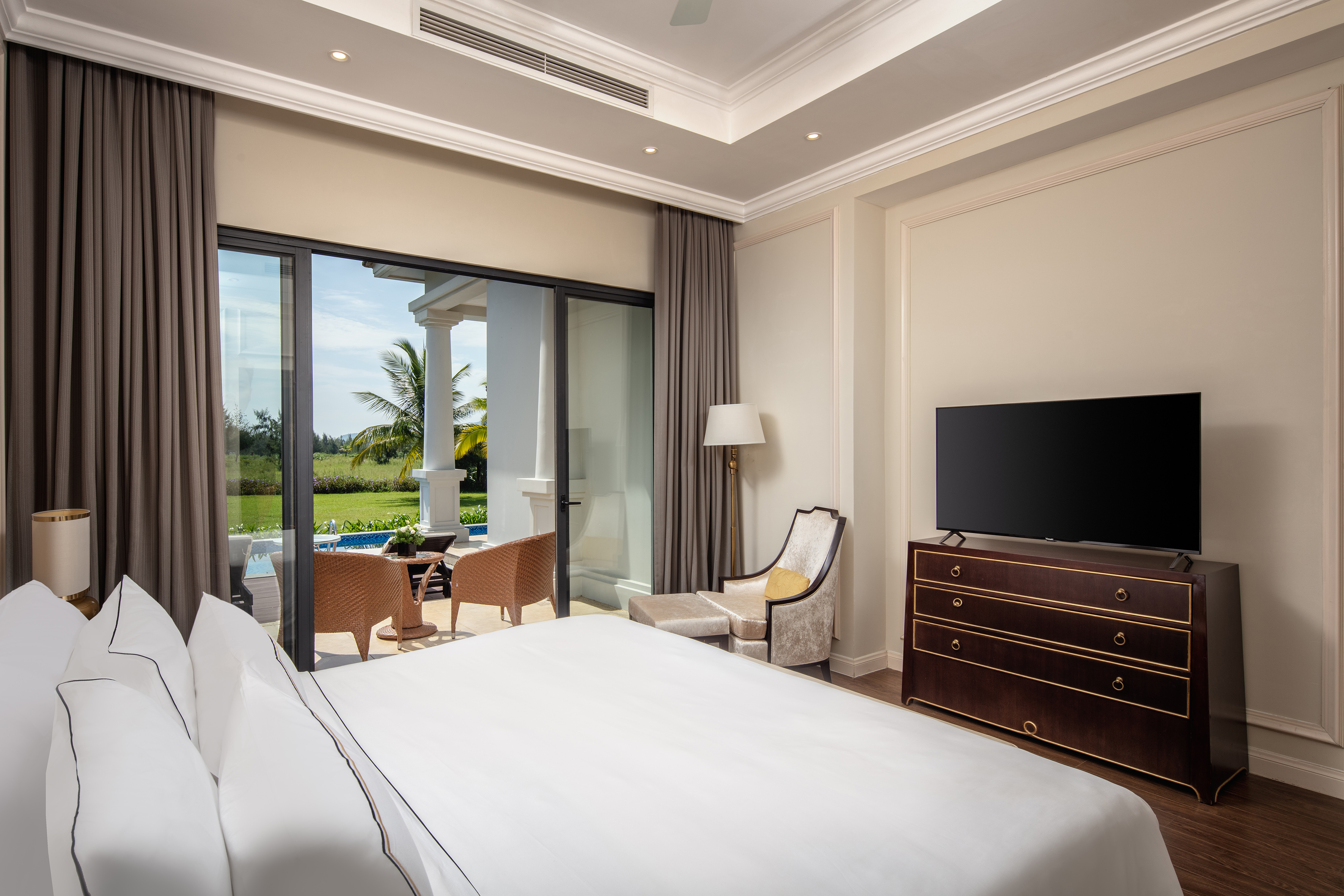 a bedroom with a television and a large window