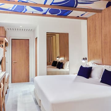 a room with a bed and a mirror