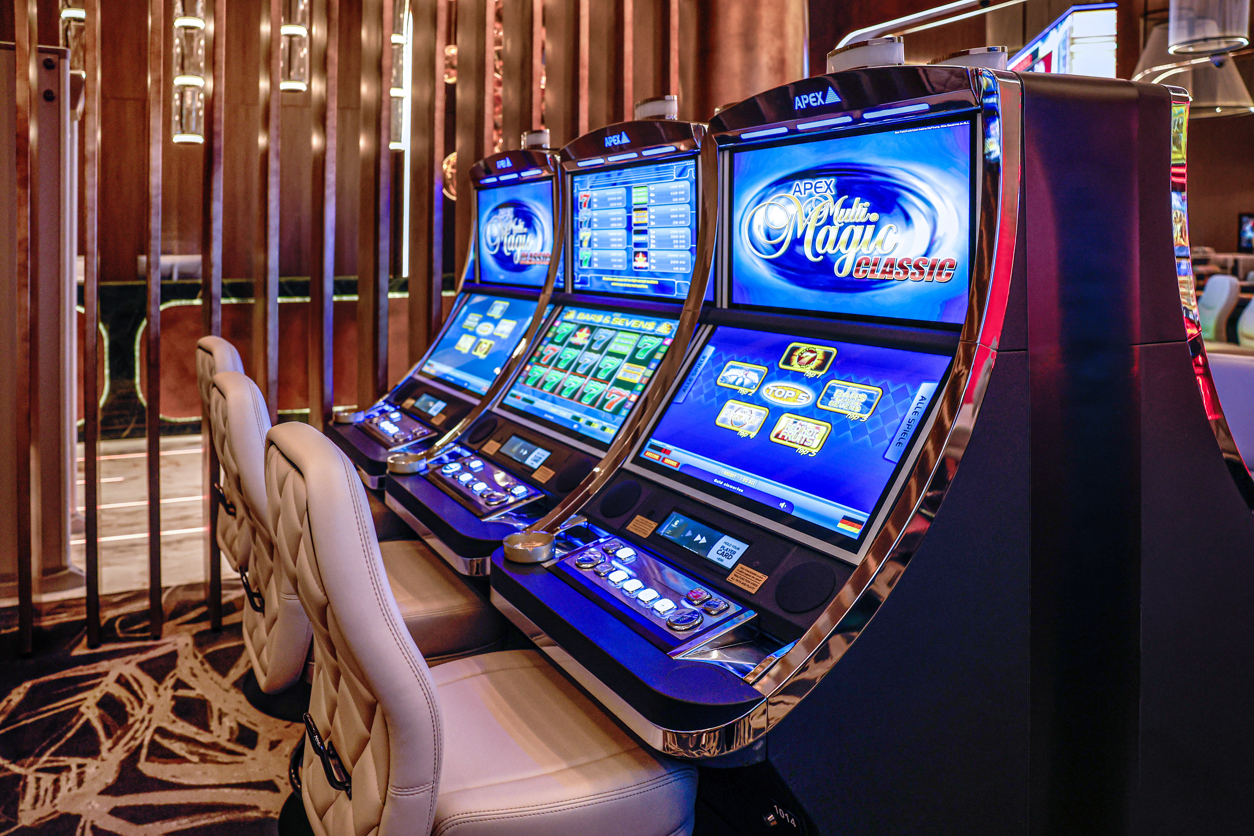 Row of Apex slot machines displaying casino games like Multi Magic Classic.