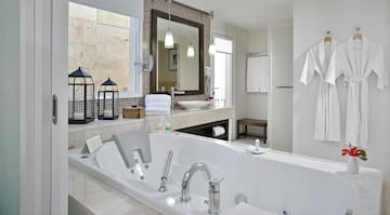 a bathroom with a bathtub and a mirror