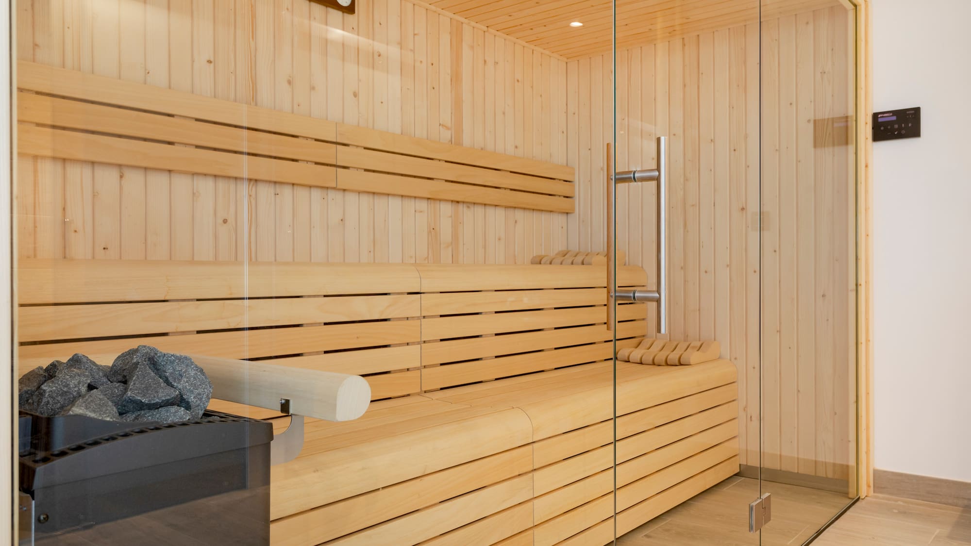 a wooden sauna with glass doors