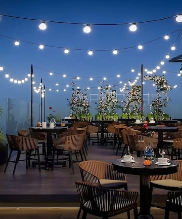a patio with tables and chairs and string lights