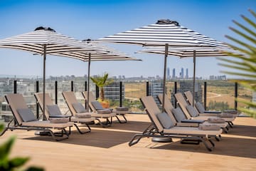 a group of chairs and umbrellas on a deck