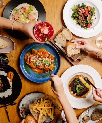 a group of people eating food on a table