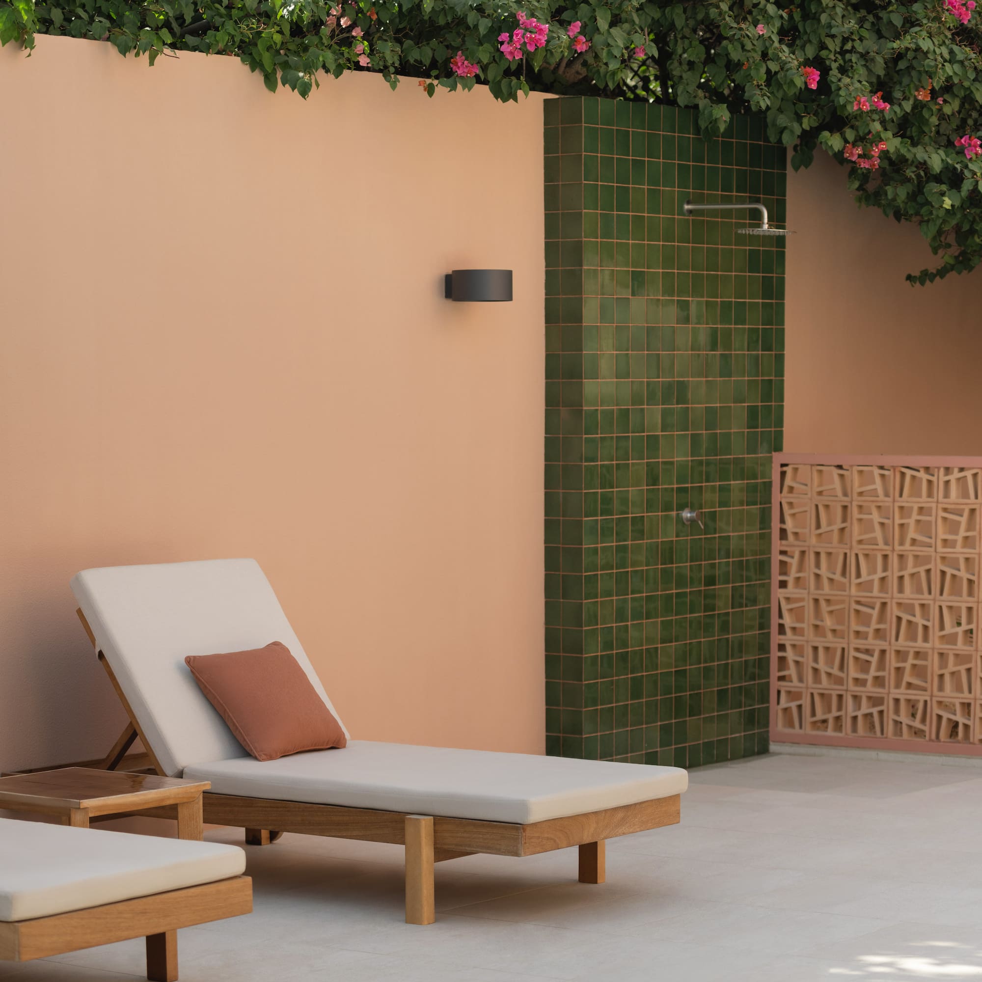 a lounge chairs outside a shower