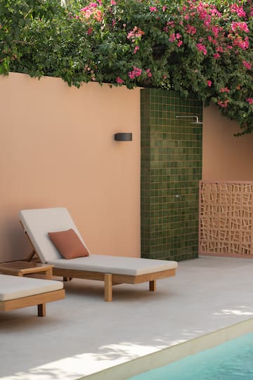 a lounge chairs outside a shower