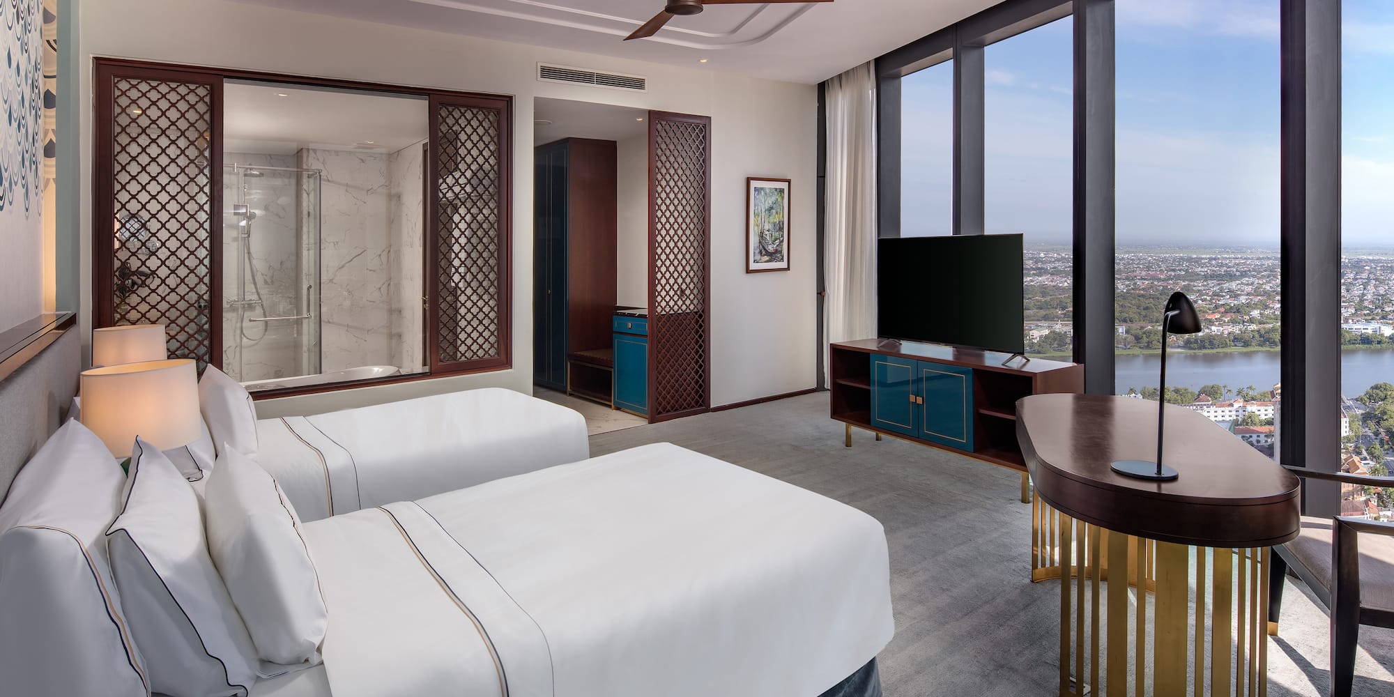 a room with two beds and a television