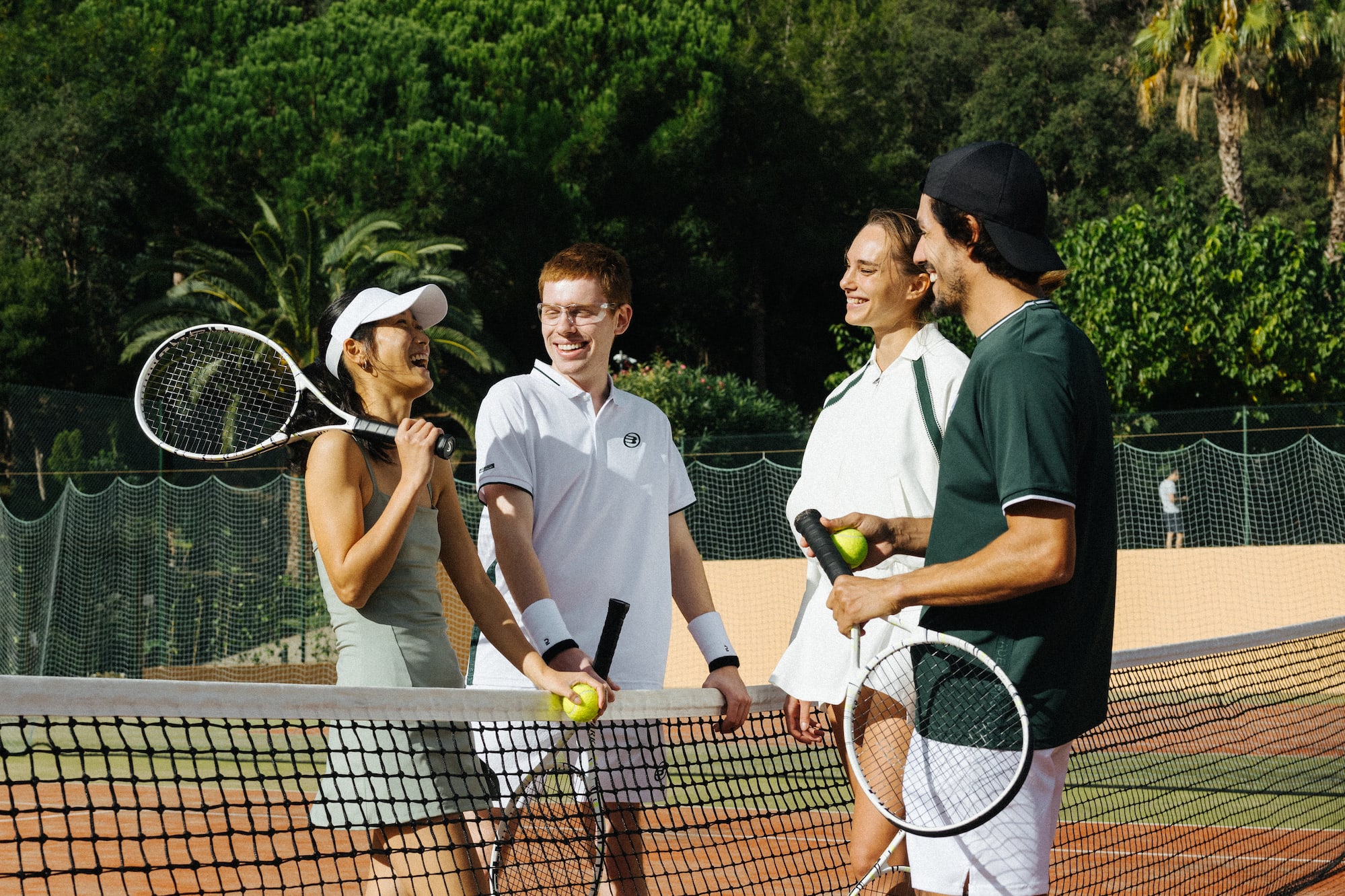 a group of people on a tennis court