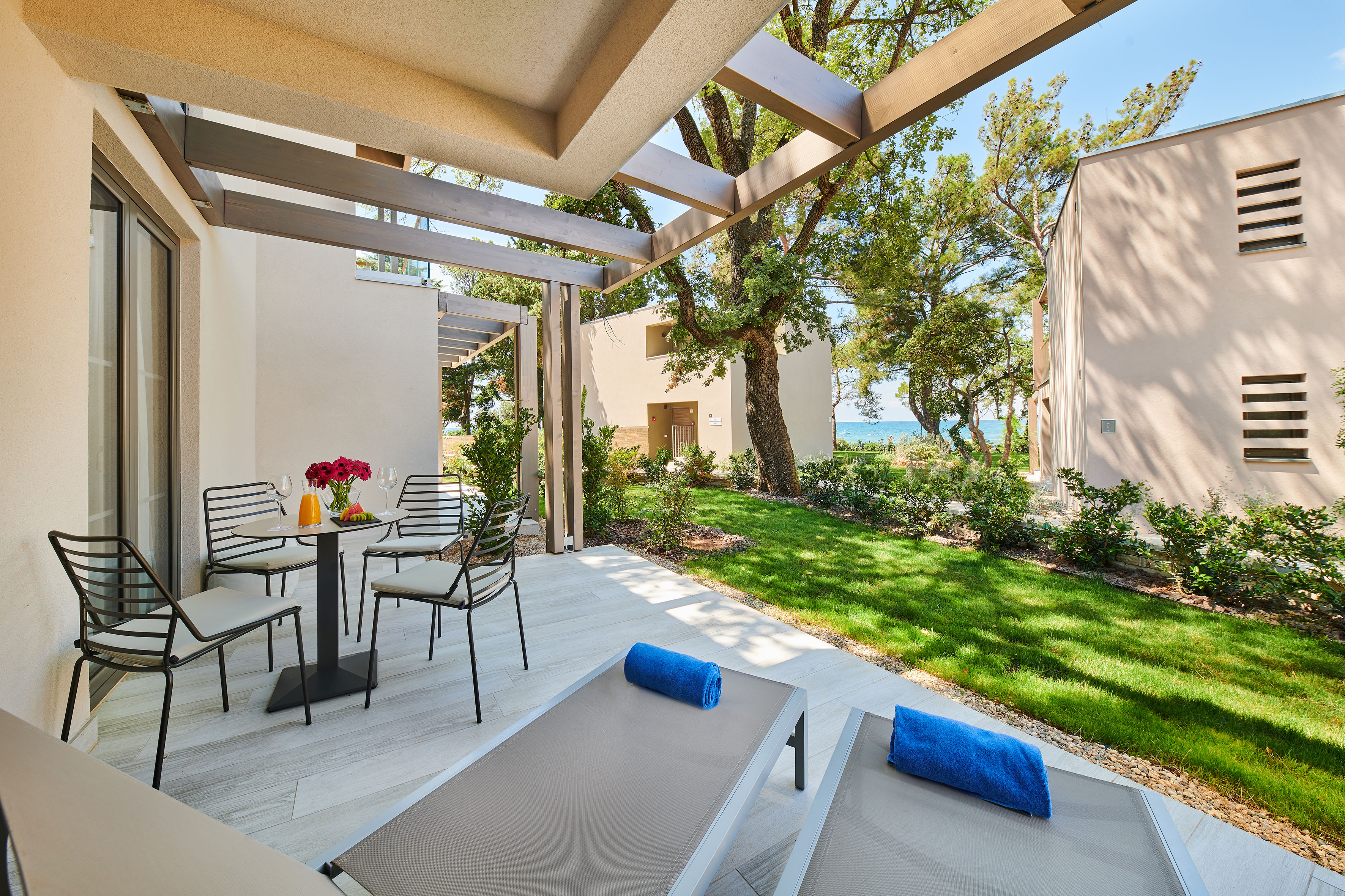 a patio with chairs and a table