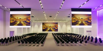 a large room with chairs and a large screen