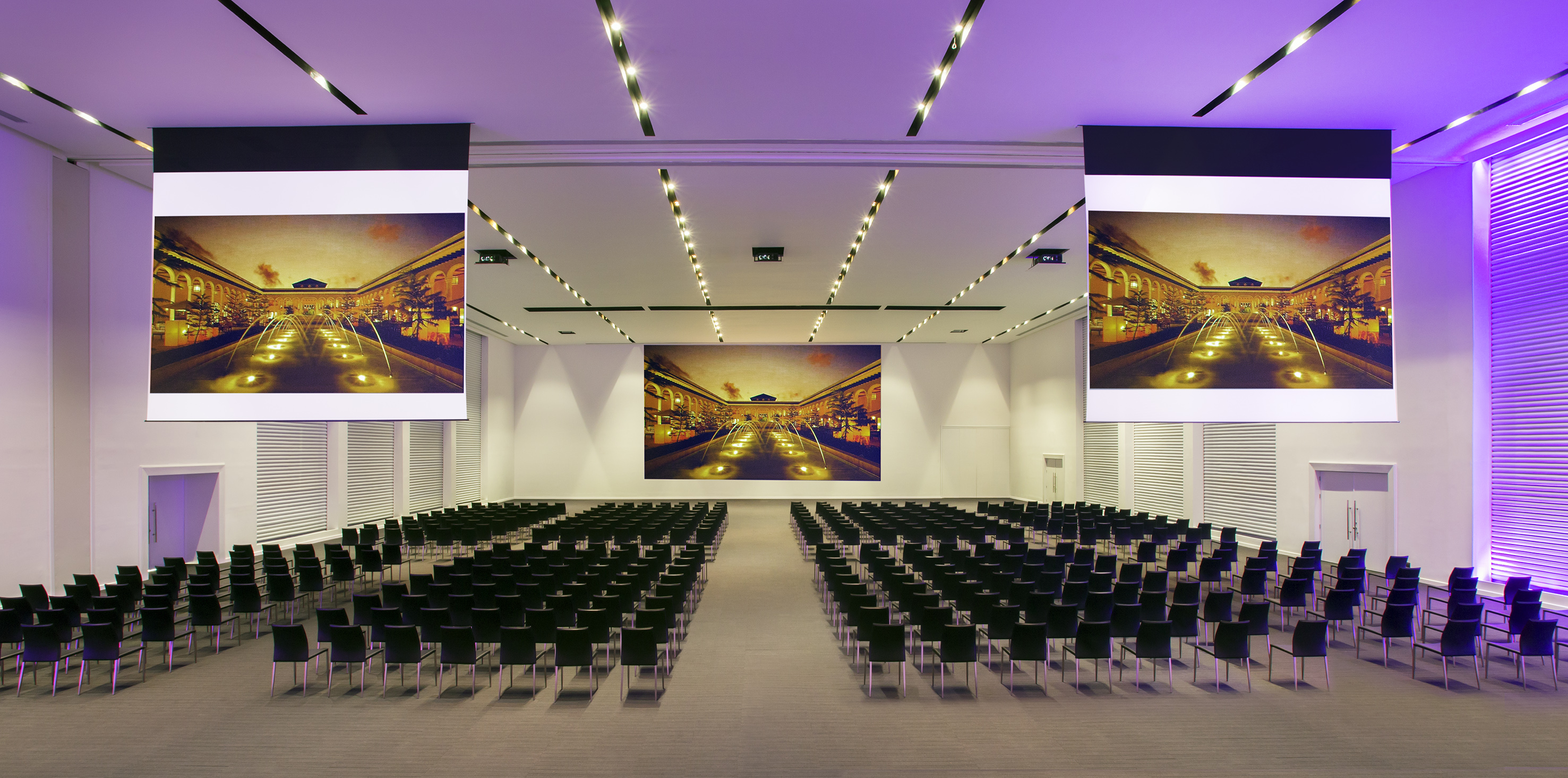 a large room with chairs and a large screen