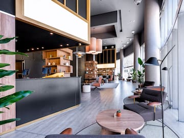 a lobby with a reception desk and chairs