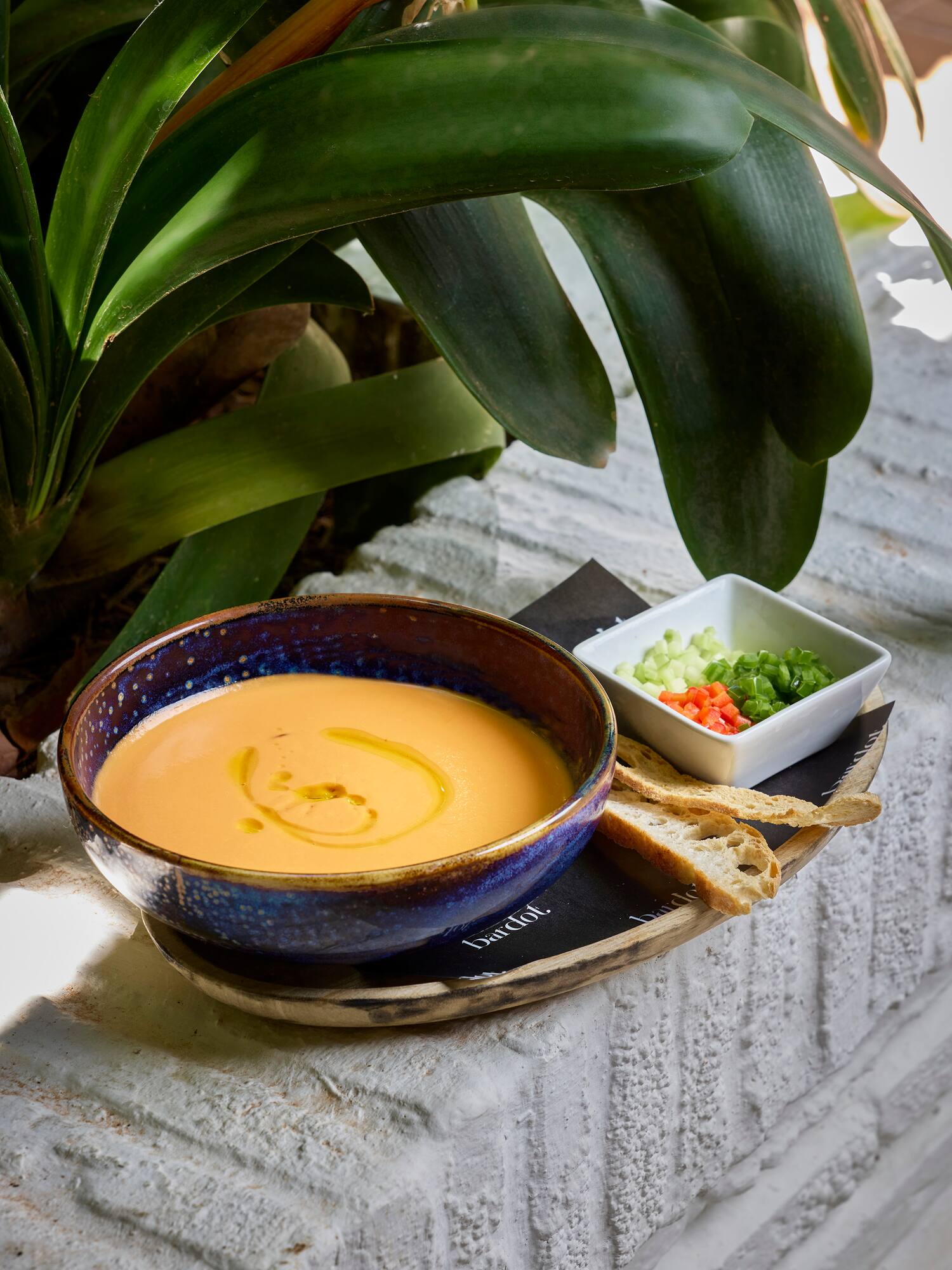 a bowl of soup and a small bowl of bread