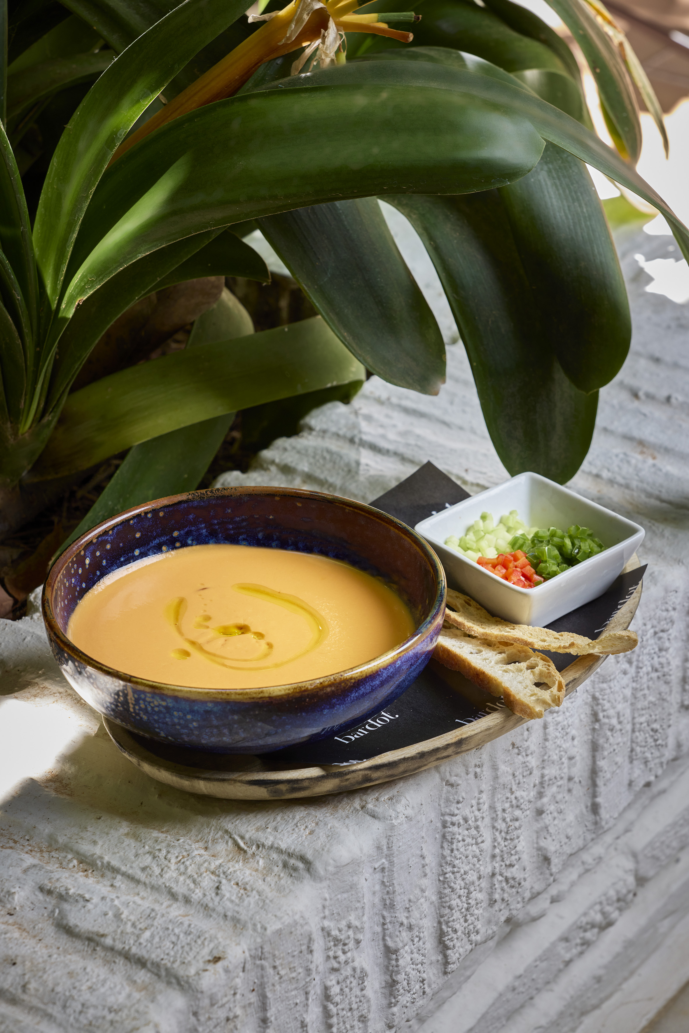 a bowl of soup and a small bowl of bread