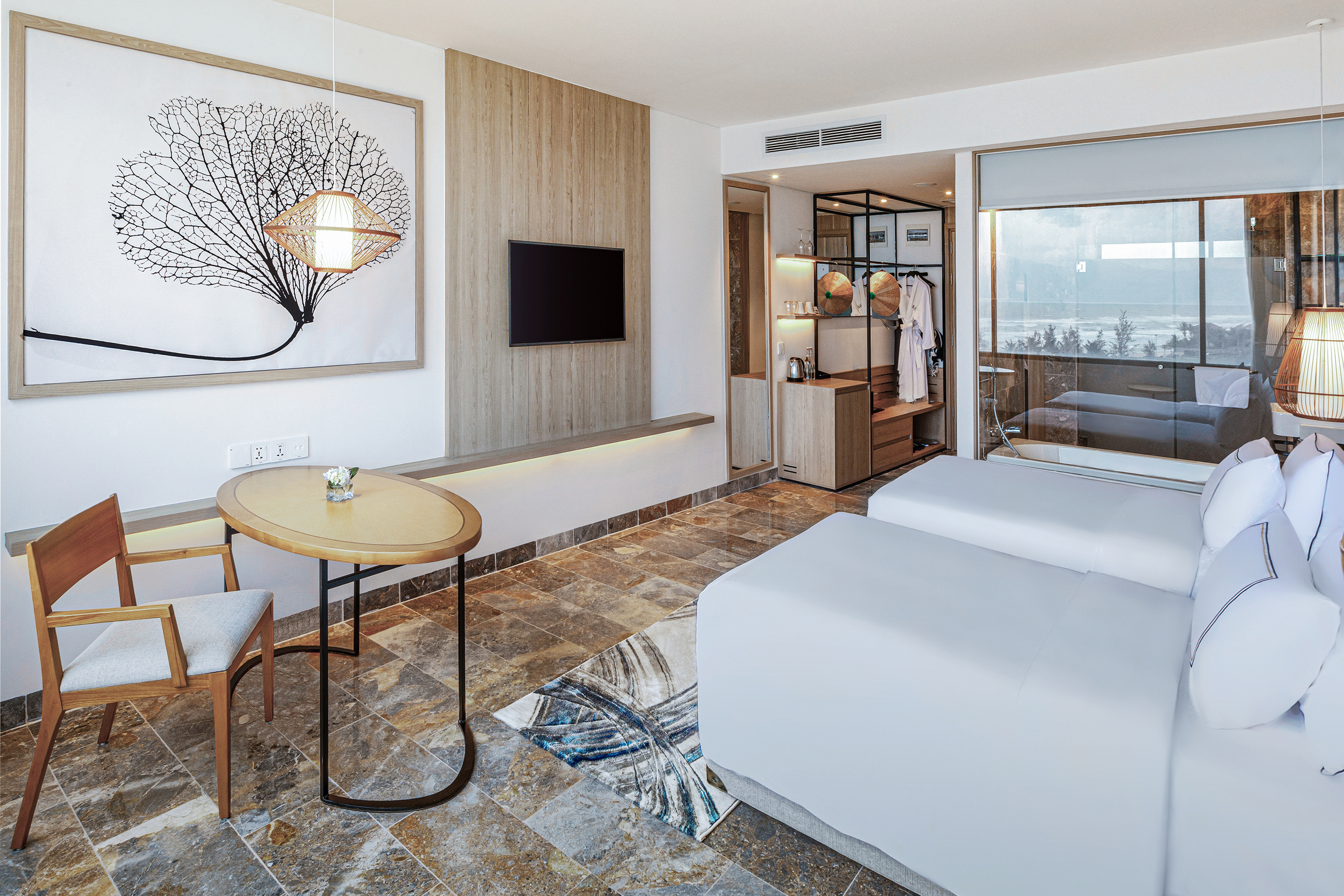 a room with two beds and a table