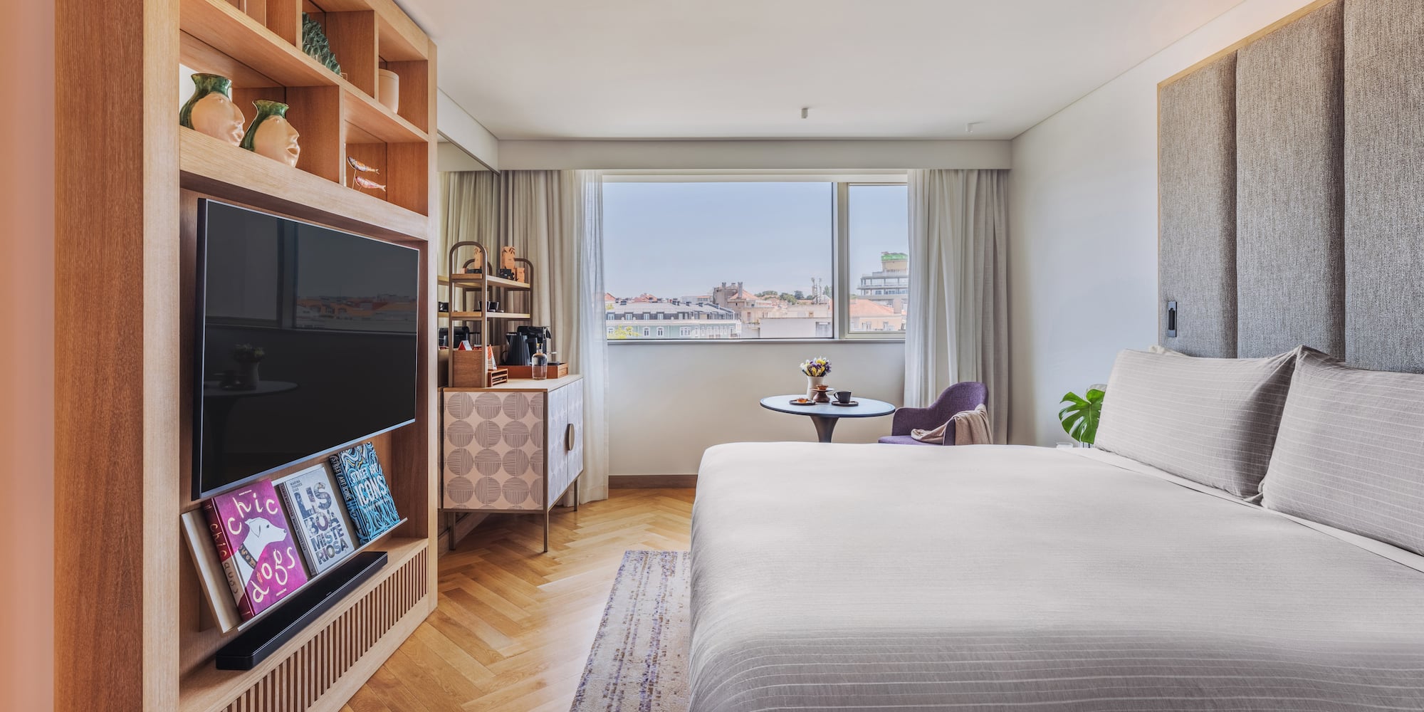 a bedroom with a tv and a bed