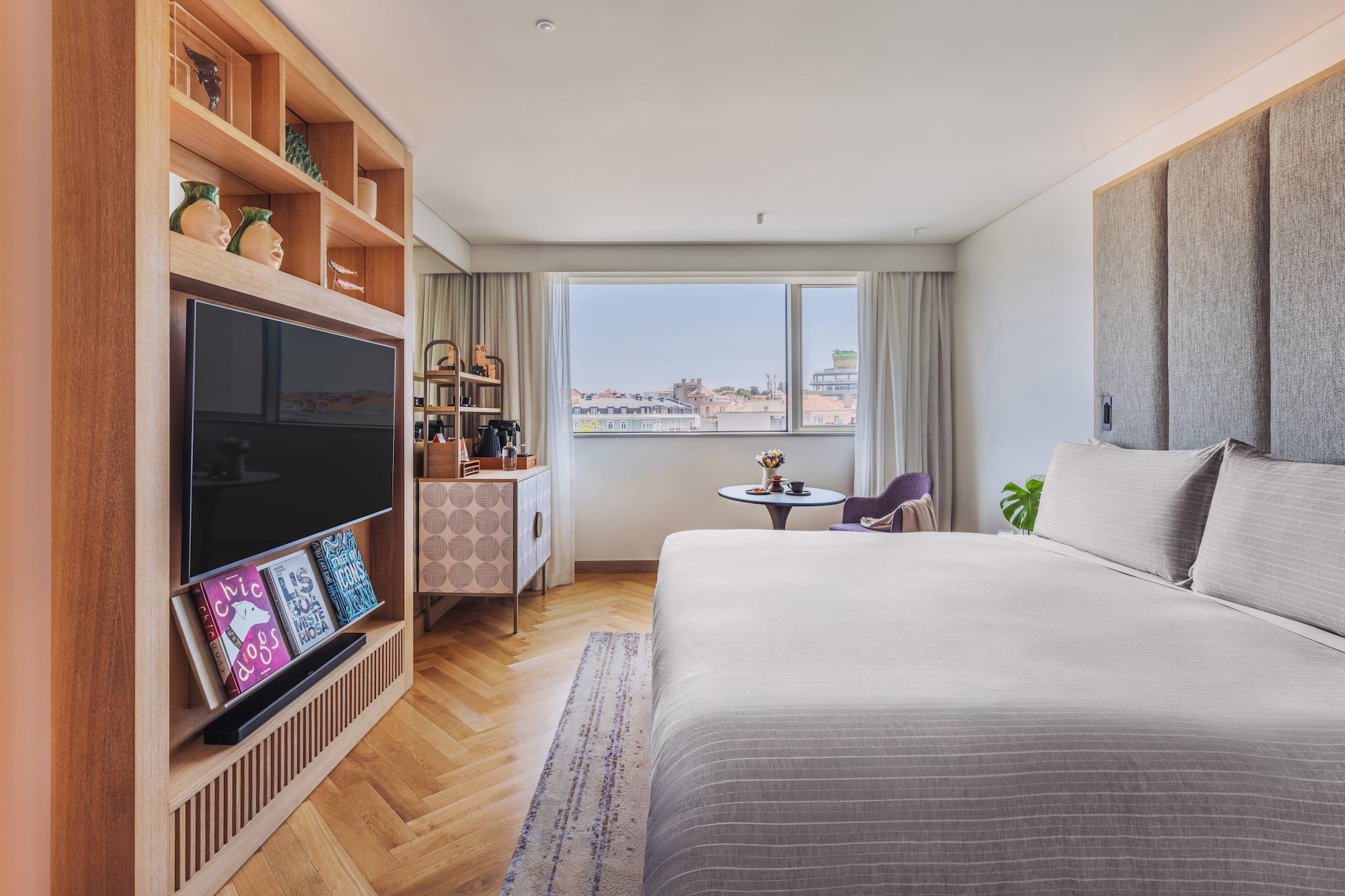 a bedroom with a tv and a bed