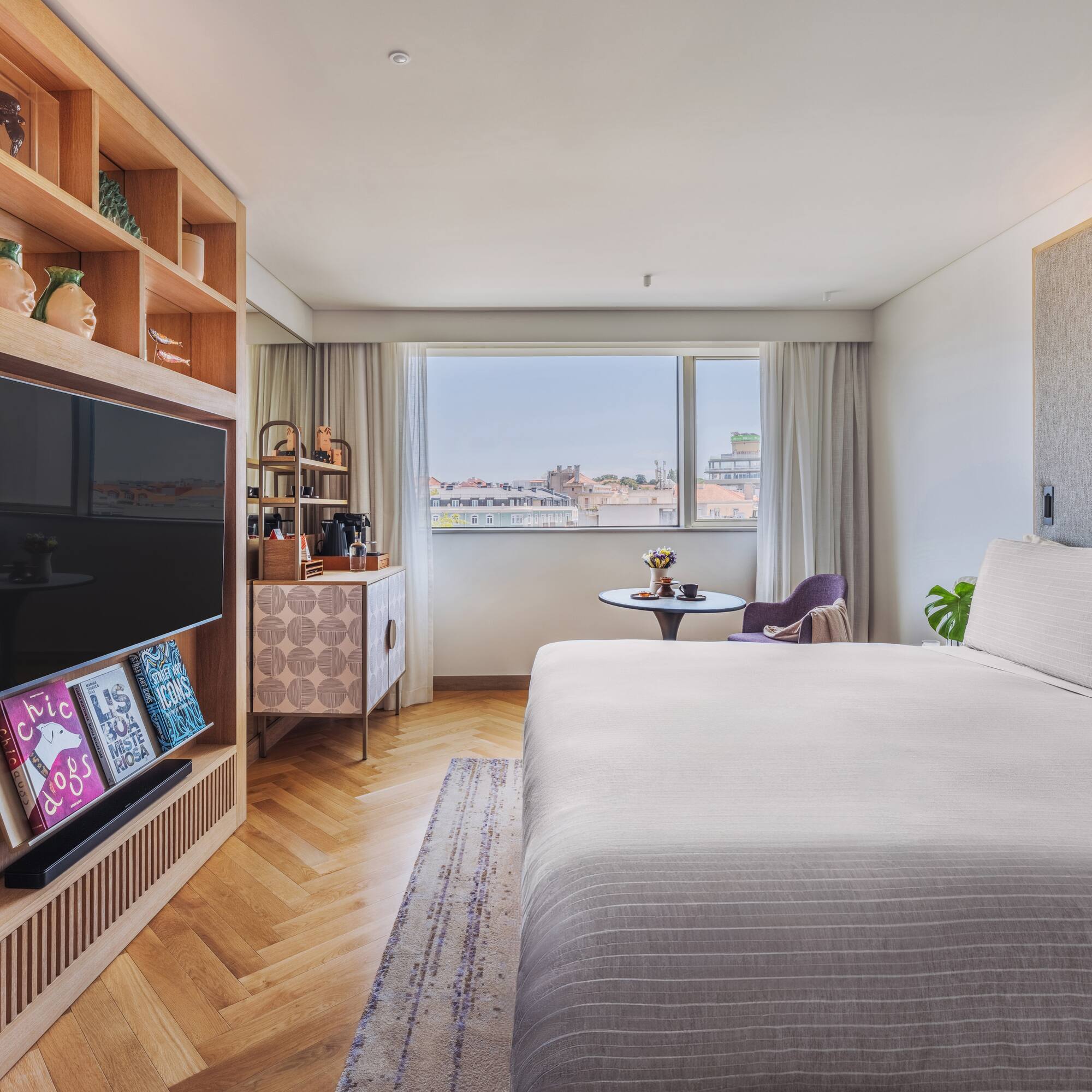 a bedroom with a tv and a bed