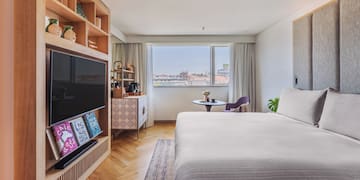 a bedroom with a tv and a bed