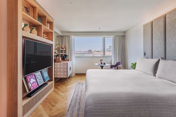 a bedroom with a tv and a bed