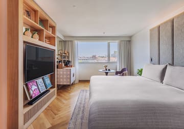 a bedroom with a tv and a bed