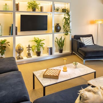 a living room with a tv and couches