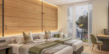 a room with two beds and a table