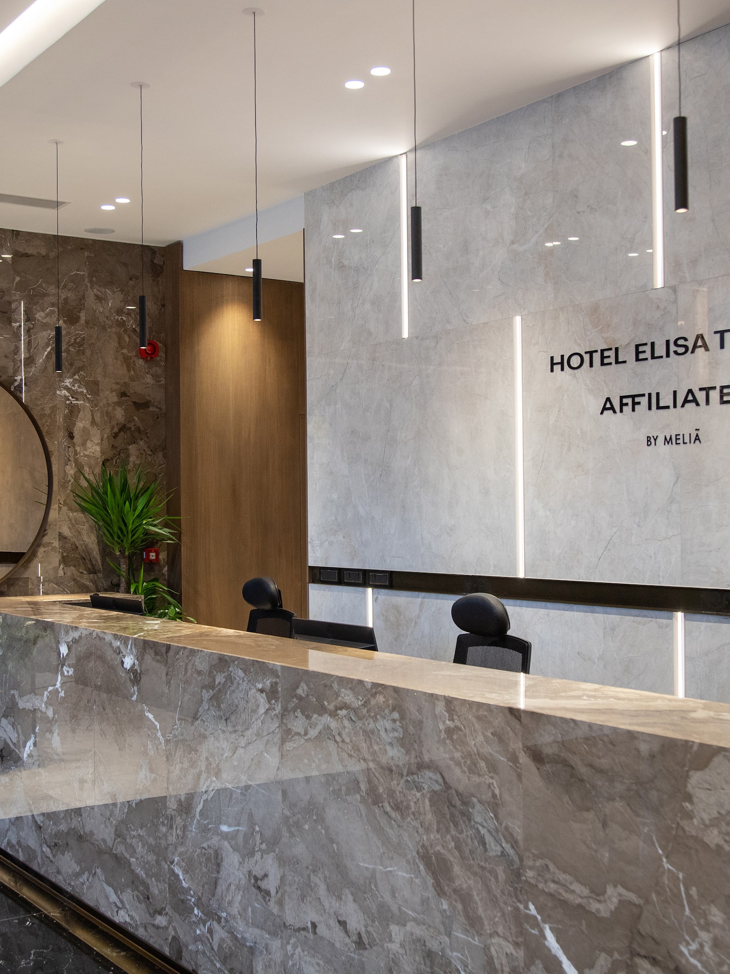 a marble reception desk in a hotel